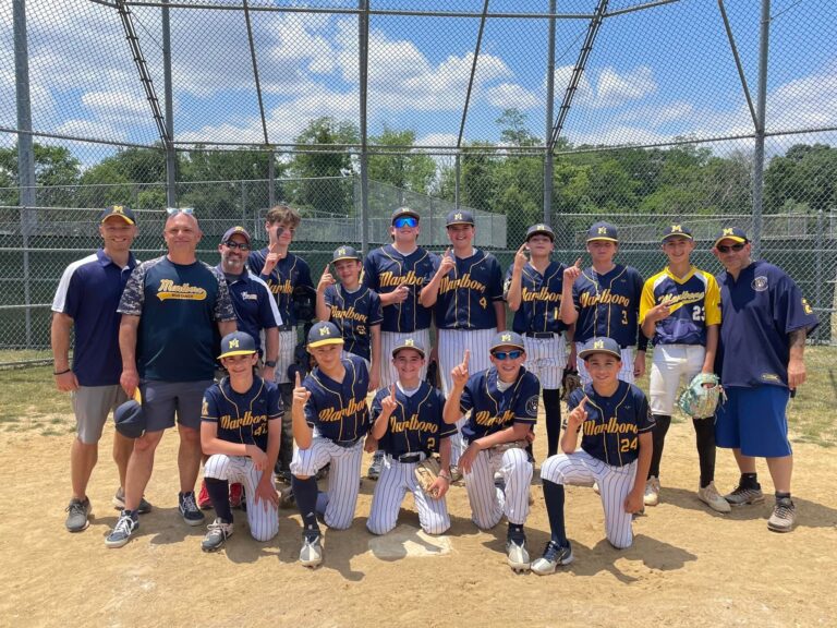 The baseball team stands together with a champions highlighting their custom baseball uniforms made in New Jersey, USA, Evo9x.